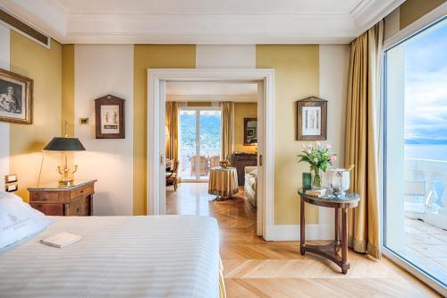 a bedroom with a bed and a large window at Excelsior Palace Portofino Coast in Rapallo