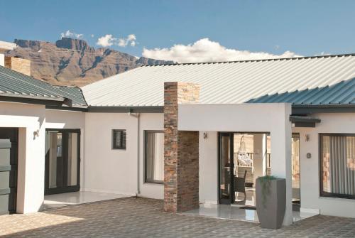 a rendering of a house with a mountain in the background at Eleven on Tumbleweed, Cathkin Estates in Champagne Valley