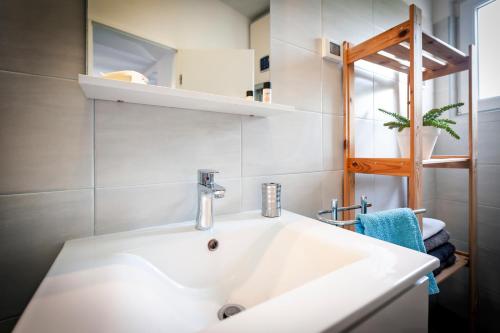 a bathroom with a white sink in a room at Apartment Cave in Rovinj