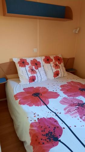 a bed with flowers painted on the sheets at ETANG PRE DE LA FONT in Cercles