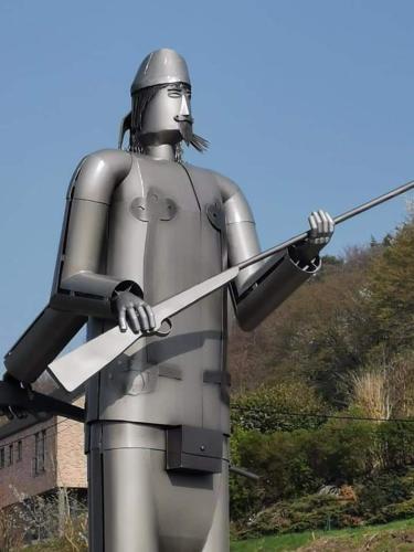 a statue of a knight holding a sword at La Majolique in Namur