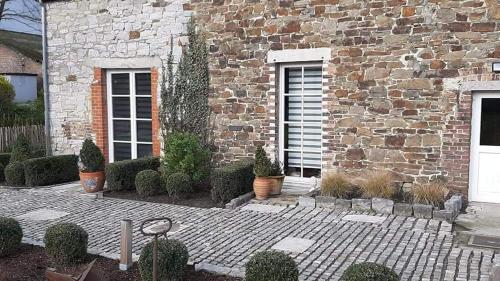 a brick building with plants in front of it at La Majolique in Namur