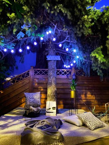 a bed with pillows and lights on a fence at Joó House in Balatonfüred