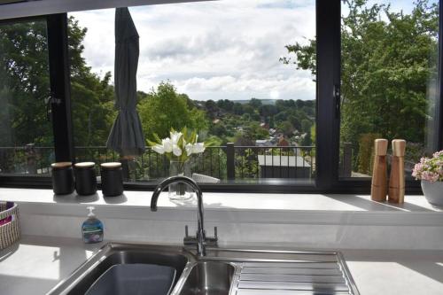 a kitchen counter with a sink and a window at The View in Shaftesbury