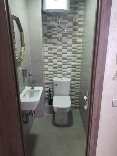 a bathroom with a toilet and a sink at APPART SMIR PARK in Tétouan