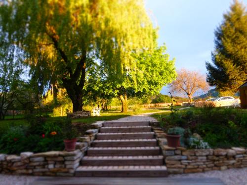 a set of stone steps in a park with trees at Chambres d'hôtes Béred Vuillemin in Baume-les-Dames
