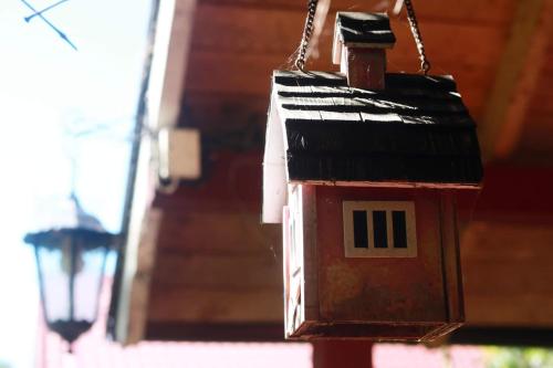 a bird house hanging from the side of a building at Namelis nr 1 Adelės sodyba in Sturmai