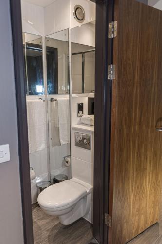 a white bathroom with a toilet and a shower at For Students Only Collegiate Eclipse Cardiff in Cardiff
