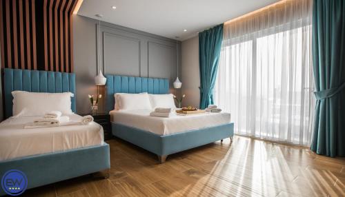 Säng eller sängar i ett rum på Blue Water Hotel Ksamil