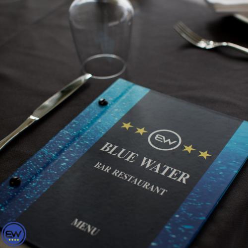 a blue napkin sitting on a table with a knife at Blue Water Hotel Ksamil in Ksamil