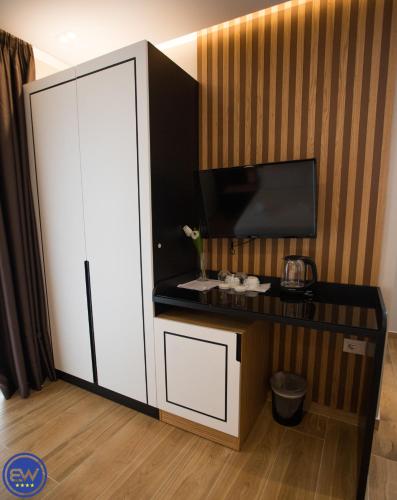 a room with a white cabinet and a tv at Blue Water Hotel Ksamil in Ksamil