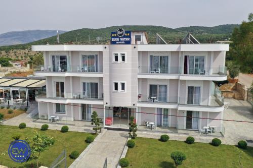 a large white building with a lot of windows at Blue Water Hotel Ksamil in Ksamil