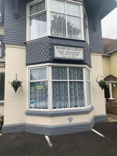 a house with a sign on the front of it at roosevelt lodge in Skegness