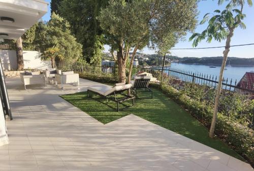 a patio with a bench and a view of the water at Villa Gloria in Cavtat