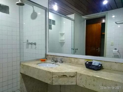 a bathroom with a sink and a mirror at Amoaras Resort in Maria Farinha