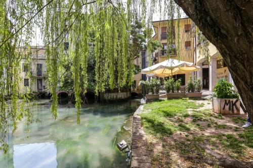 a view of a river in a city with buildings at Treviso City Town 2 in Treviso