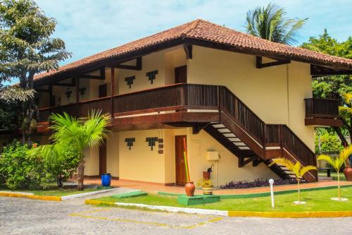 a house with a staircase on the side of it at Amoaras Resort in Maria Farinha