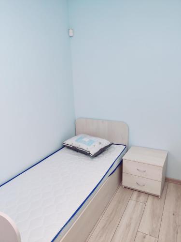 a small bedroom with a bed and a dresser at Будинок в Одесі біля моря 16 станція Фонтану in Odesa