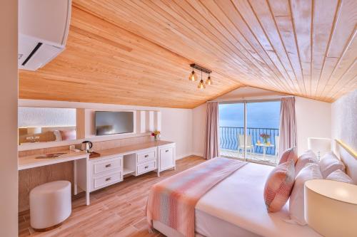 a bedroom with a large bed with a view of the ocean at Hilaris Kas in Kaş