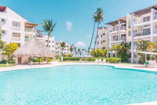 a swimming pool in front of some apartment buildings at Playa Turquesa Ocean Club in Punta Cana