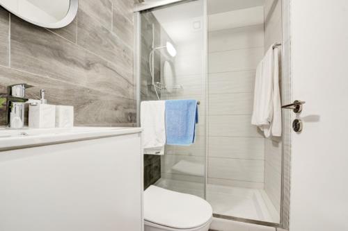 a bathroom with a shower and a toilet and a sink at MyHome DeLux, Napa Blue 3Bed with Pool in Ayia Napa