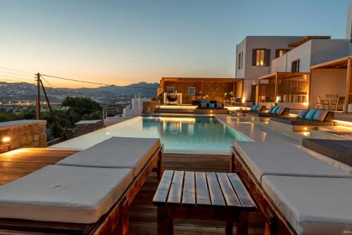 a swimming pool with a bench on a house at CASA DI PIETRA MYKONOS in Klouvas