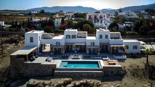 an aerial view of a house with a swimming pool at CASA DI PIETRA MYKONOS in Klouvas