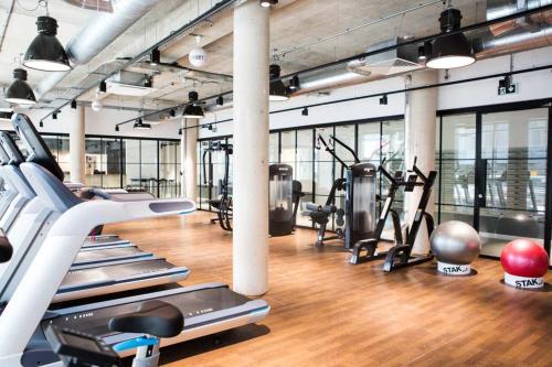 a gym with several treadmills and cardio machines at Chapter Lewisham in London in London