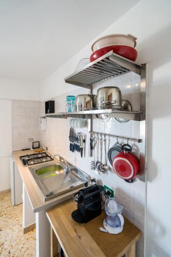a kitchen with a sink and some pots and pans at Borgo Canneto in Rodi Garganico