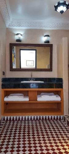 a bathroom with a sink and a mirror at Riad Barroko in Marrakech