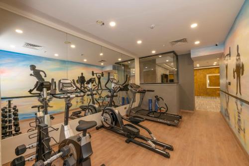 a gym with treadmills and exercise equipment in a room at The Conforium Hotel Van in Van