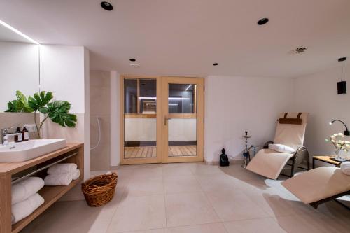 a bathroom with a sink and a mirror at Bühlhof Appartements in Lech am Arlberg