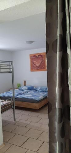 a bedroom with a bed and a ladder in a room at Feriendomizil-Roger-Wohnung-1 in Leipzig