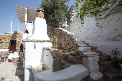 a group of stairs in a stone wall at Flaskos Village Fanari in Mýkonos City