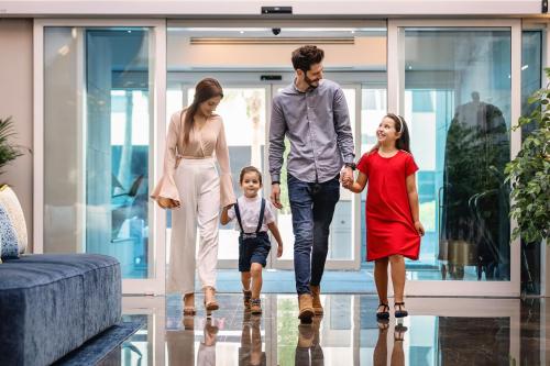 a family walking through a house at Centara West Bay Hotel & Residences Doha in Doha