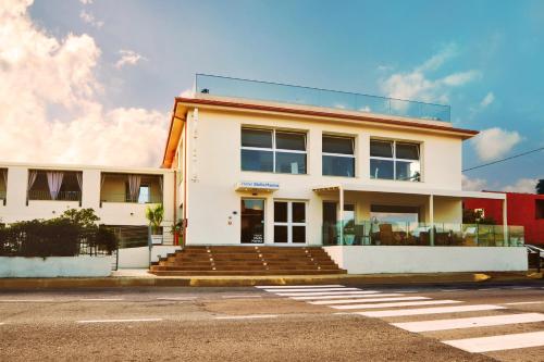 a white building with a lot of windows at Hotel Stella Marina in San Teodoro