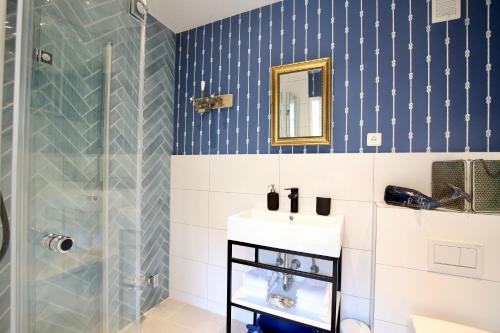 a bathroom with a sink and a shower at Lighthousestudio & Spa in Wangerooge