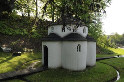 a small white building with a black roof at Skupljen Resort: Enjoy the Freedom! in Vladimirci