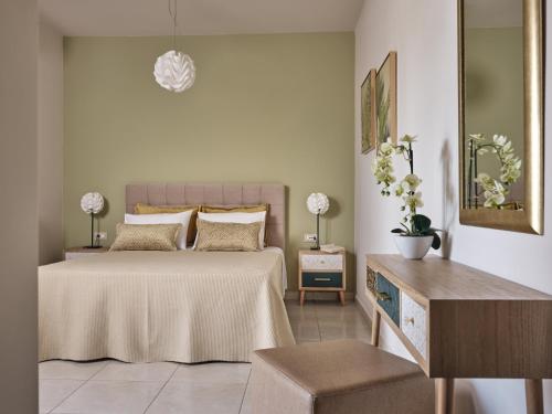 a bedroom with a bed and a table and a mirror at La Palma Apartments - 2km from Zakynthos Town, by ZanteWize in Zakynthos Town
