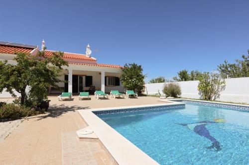 a swimming pool in front of a house at Villa Monte Bixo - Free WIFI . Swimmning Pool - BY BEDZY in Assumadas