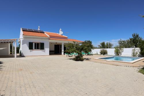 a house with a swimming pool in front of it at Villa Monte Bixo - Free WIFI . Swimmning Pool - BY BEDZY in Assumadas