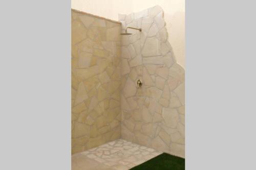 a shower with a glass door in a bathroom at Villa Elisa residenza Agorà Villasimius in Villasimius