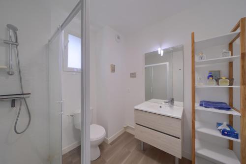 a bathroom with a shower and a toilet and a sink at La Carasse in Lège-Cap-Ferret
