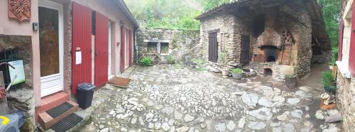a stone walkway in front of a building at Cèdres Bleus de Joany chez Nathalie in Viviez