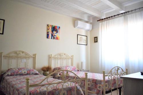 a bedroom with two beds and a window at B&B Certe Notti in Agrigento