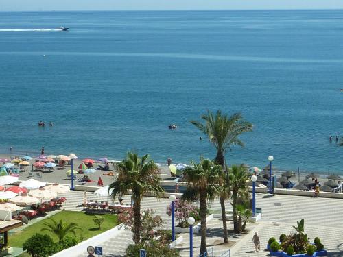 a view of a beach with umbrellas and the ocean at Madrid-M504 in Torrox Costa