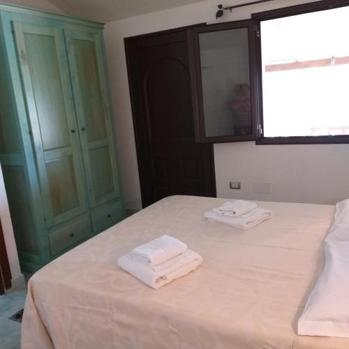 Postel nebo postele na pokoji v ubytování Agriturismo Funtan'Arva