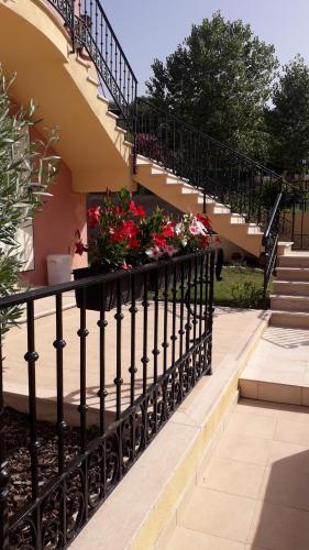 a black railing with flowers on a staircase at I Registi in Scalea