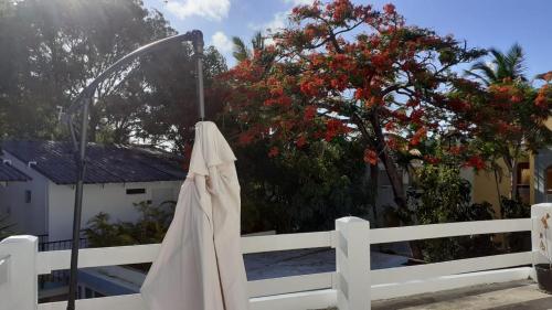 a white fence with a robe hanging on it at Room #23 at Waterfront Playa Alicia in Sosúa