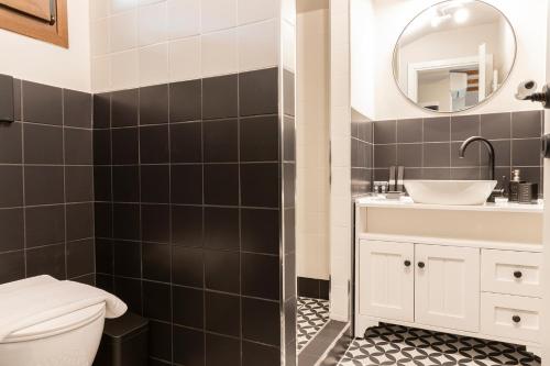 a bathroom with a toilet and a sink and a mirror at Villa La Varik 1 in Litochoro